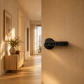 Serrure connectée noire installée sur une porte d'entrée d'appartement dans un hall élégant